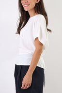 Blusa con fiocco sulla schiena