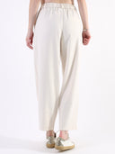 Pantalone baggy con pences e vita asimmetrica