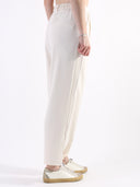 Pantalone baggy con pences e vita asimmetrica