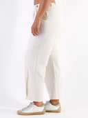Pantalone baggy con pences e vita asimmetrica
