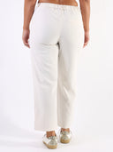 Pantalone baggy con pences e vita asimmetrica