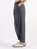 Pantalone baggy con pences e vita asimmetrica