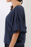 Blusa plumetis con maniche volant