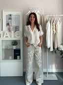 Jeans beige a palazzo con ricami di perline