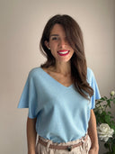 T-shirt azzurra con brillantini colorati